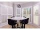 Breakfast nook with a round table, black chairs, and white plantation shutters at 2875 Clary Hill Ne Dr, Roswell, GA 30075