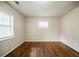 Simple bedroom with hardwood floors and window at 3738 Larkspur Ter, Decatur, GA 30032
