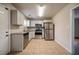 Renovated kitchen, featuring stainless steel appliances and granite countertops at 3738 Larkspur Ter, Decatur, GA 30032