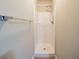 Small shower stall with tiled floor and grab bar at 3738 Larkspur Ter, Decatur, GA 30032