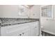 Bathroom with granite countertop and white cabinets at 4071 Williamsburg Dr, Atlanta, GA 30337