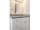 Bathroom boasts granite countertop and white cabinets at 4071 Williamsburg Dr, Atlanta, GA 30337