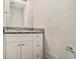 Bathroom features granite countertop and white cabinets at 4071 Williamsburg Dr, Atlanta, GA 30337