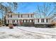 Two-story house with gray siding, red door, and a snow-covered yard at 4071 Williamsburg Dr, Atlanta, GA 30337