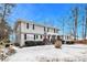 Two-story house with gray siding, red door, and snow on the ground at 4071 Williamsburg Dr, Atlanta, GA 30337