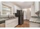 Updated kitchen with white cabinets, granite countertops, and stainless steel appliances at 4071 Williamsburg Dr, Atlanta, GA 30337