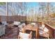 Spacious deck with wooden furniture, overlooking a wooded area at 1550 Park Creek Ne Ln, Brookhaven, GA 30319