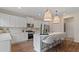 Modern kitchen with white cabinets and a large island at 2771 Dolce Rd, Dacula, GA 30019