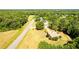 Aerial view of house nestled among trees with a long road in front at 627 Honey Creek Rd, Mcdonough, GA 30252