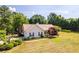 House with a red door, dark shutters, and landscaping, in a large lot setting at 627 Honey Creek Rd, Mcdonough, GA 30252