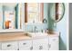 Elegant bathroom with a white vanity and oval mirror at 627 Honey Creek Rd, Mcdonough, GA 30252