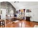 Living room with brick accent wall and hardwood floors at 627 Honey Creek Rd, Mcdonough, GA 30252