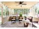 Relaxing screened porch with wicker furniture and ceiling fan at 627 Honey Creek Rd, Mcdonough, GA 30252