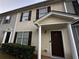 Two-story townhouse with tan siding, brown shutters, and a brown door at 990 Harbins Rd # 5D, Norcross, GA 30093