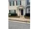 Tan two-story townhouse with brown shutters and a brown door at 990 Harbins Rd # 5D, Norcross, GA 30093