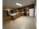 Kitchen with wood cabinets, stainless steel appliances, and tile floor at 990 Harbins Rd # 5D, Norcross, GA 30093