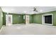 Large unfinished basement room with green walls and carpet at 1048 Standard Ne Dr, Atlanta, GA 30319