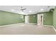 Large unfinished basement room with green walls and carpet at 1048 Standard Ne Dr, Atlanta, GA 30319