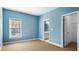 Bedroom with light blue walls, carpeting, and en-suite bathroom at 1048 Standard Ne Dr, Atlanta, GA 30319