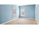 Light blue bedroom with neutral carpeting and two windows at 1048 Standard Ne Dr, Atlanta, GA 30319