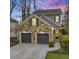 Charming two-story home featuring a stone facade, two-car garage, and inviting front entrance at 1048 Standard Ne Dr, Atlanta, GA 30319