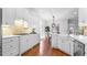 White kitchen with island, stainless steel appliances, and hardwood floors at 1048 Standard Ne Dr, Atlanta, GA 30319