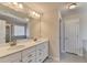 Bathroom with double vanity, large mirror and tile flooring at 2329 Village Grove Dr, Suwanee, GA 30024