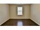 Bedroom with dark hardwood floors and window at 2329 Village Grove Dr, Suwanee, GA 30024