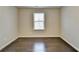 Bright bedroom featuring hardwood floors and a window with blinds at 2329 Village Grove Dr, Suwanee, GA 30024