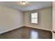 Bedroom with dark hardwood floors and window at 2329 Village Grove Dr, Suwanee, GA 30024