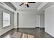 Large bedroom with dark hardwood floors and a window with blinds at 2329 Village Grove Dr, Suwanee, GA 30024