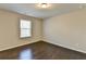 Spacious bedroom with dark hardwood floors and a large window at 2329 Village Grove Dr, Suwanee, GA 30024