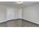 Well-lit bedroom with double doors to closet and hardwood floors at 2329 Village Grove Dr, Suwanee, GA 30024