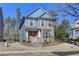 Two-story house with blue siding, brick accents, and a peach-colored door at 2329 Village Grove Dr, Suwanee, GA 30024