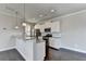 Modern kitchen with white shaker cabinets and granite countertops at 2329 Village Grove Dr, Suwanee, GA 30024