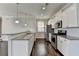 Modern kitchen with granite countertops, stainless steel appliances, and white cabinets at 2329 Village Grove Dr, Suwanee, GA 30024