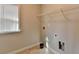 Laundry room with window, shelving and floor tile at 2329 Village Grove Dr, Suwanee, GA 30024