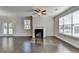 Spacious living room with hardwood floors, fireplace, and multiple windows at 2329 Village Grove Dr, Suwanee, GA 30024