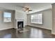 Spacious living room with hardwood floors, fireplace and large windows at 2329 Village Grove Dr, Suwanee, GA 30024