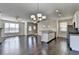 Open living room with hardwood floors and a kitchen island at 2329 Village Grove Dr, Suwanee, GA 30024