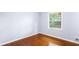 Bedroom with hardwood floors and a window overlooking backyard at 2666 Frontier Trl, Atlanta, GA 30341