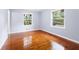 Hardwood floor bedroom with two windows and access to hallway at 2666 Frontier Trl, Atlanta, GA 30341