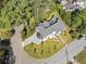 An aerial view of a white home with manicured lawn and mature trees, showcasing the property's landscaping at 464 Pine Tree Ne Dr, Atlanta, GA 30305