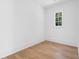 Simple bedroom with hardwood floors and a single window at 464 Pine Tree Ne Dr, Atlanta, GA 30305