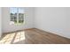 Light-filled bedroom with hardwood floors and large window at 464 Pine Tree Ne Dr, Atlanta, GA 30305