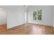 Light-filled bedroom with hardwood floors and large window at 464 Pine Tree Ne Dr, Atlanta, GA 30305