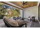 Relaxing covered patio with seating area, ceiling fan, and views of the backyard at 464 Pine Tree Ne Dr, Atlanta, GA 30305