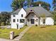 Two-story white house with gray roof, stone accents, and landscaped lawn at 464 Pine Tree Ne Dr, Atlanta, GA 30305