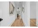 Long hallway with hardwood floors and art at 464 Pine Tree Ne Dr, Atlanta, GA 30305