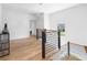 Upstairs hallway with modern railing and hardwood floors at 464 Pine Tree Ne Dr, Atlanta, GA 30305